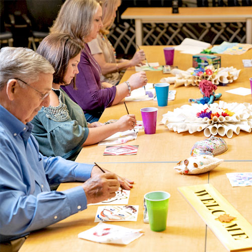 Image of patients and families in group art therapy