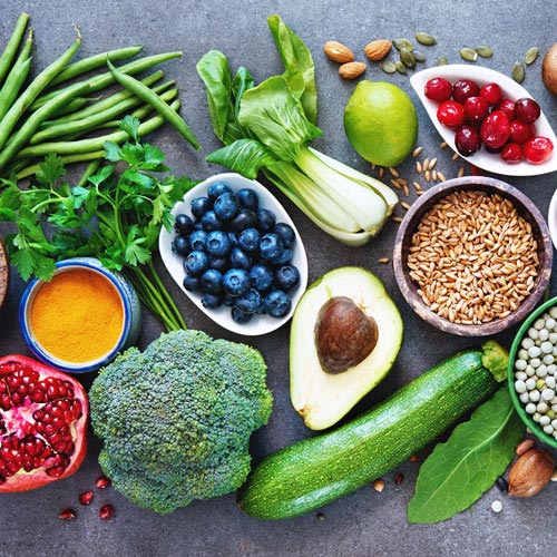 An assortment of healthy foods, including fruits, vegetables and nuts
