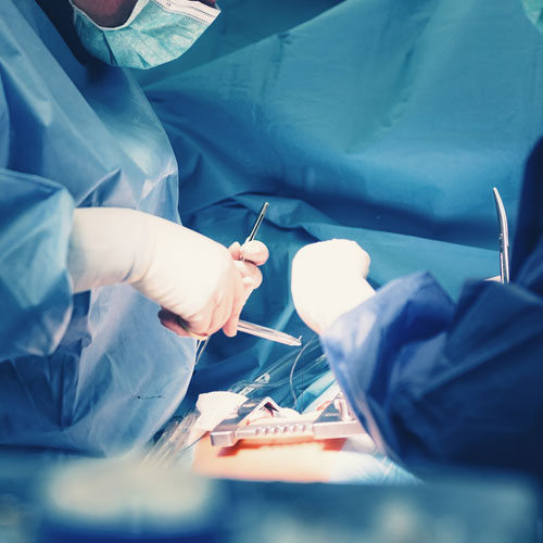 Heart surgeons perform a heart operation in the OR