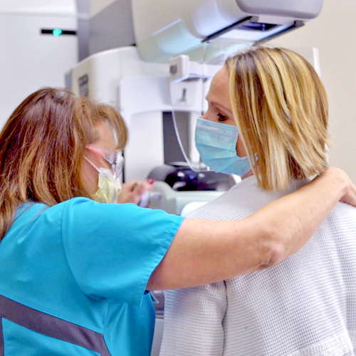 Video still of patient undergoing a mammogram