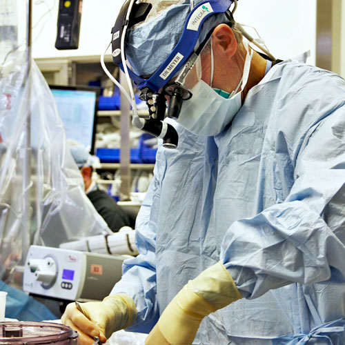 Surgeon performing heart transplant surgery